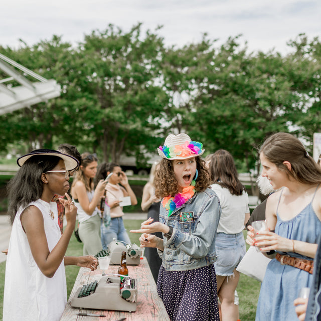 Group of people at an outdoor party with one individual looking surprised.